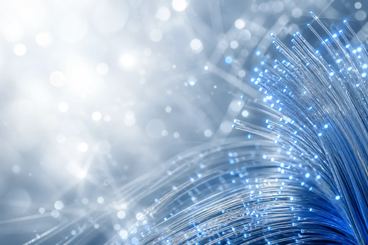 Blue-lit optical fibers sweeping across a bright white background